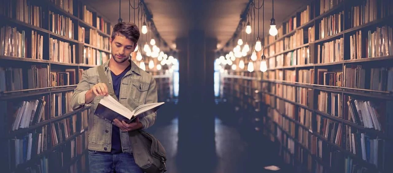 A focused student working in a modern university library